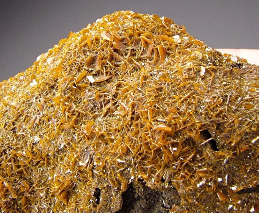 Wulfenite, What is it and how does it form and where is it's primary location of discovery?