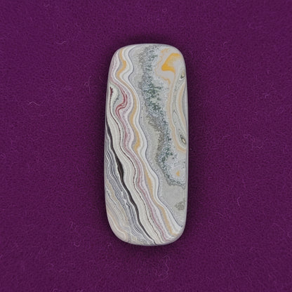 Heil Garbage Truck Fordite Free Form Caboceon, Heil (Milwaukee, WI) 41x17x3mm, 15.85ct