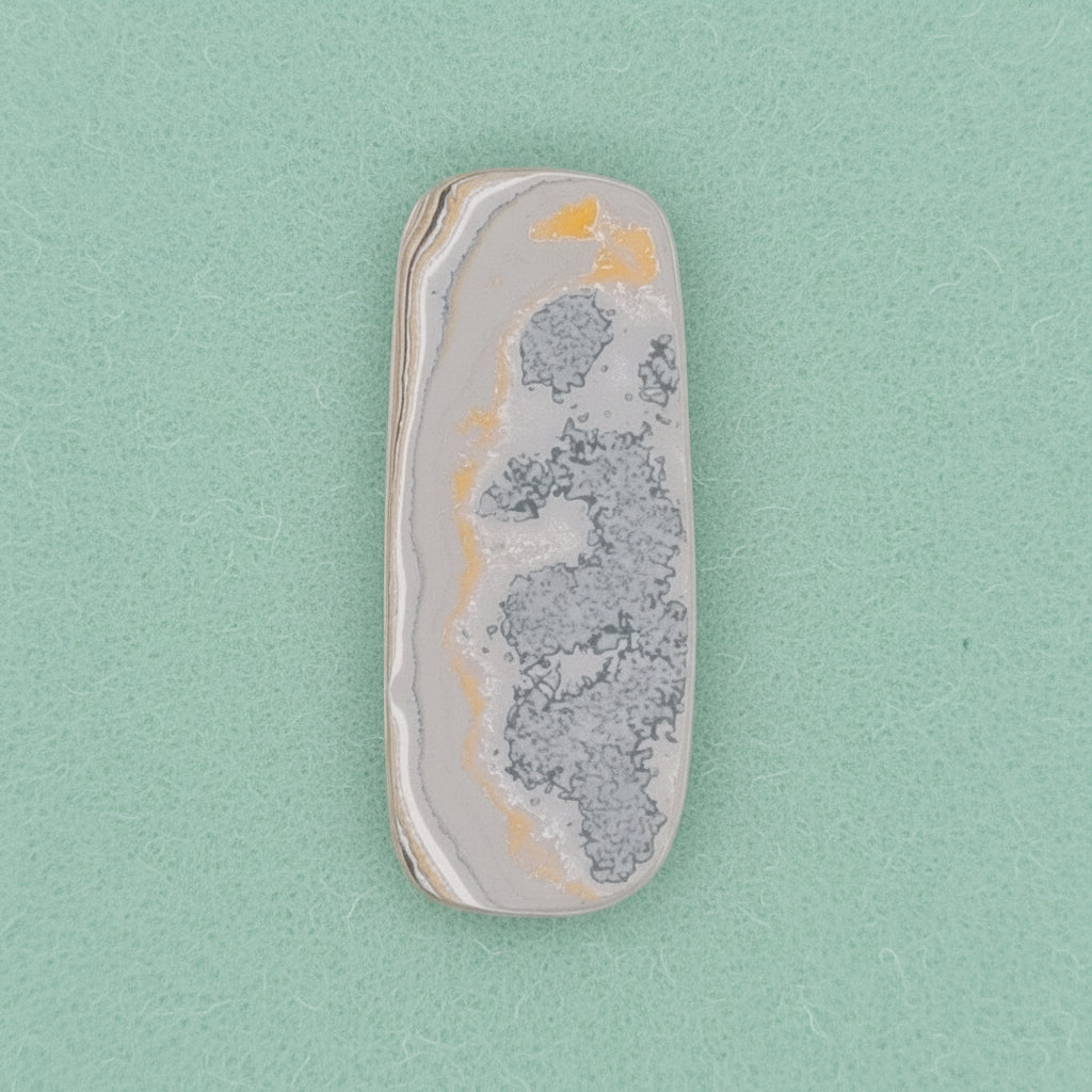 Heil Garbage Truck Fordite Free Form Caboceon, Heil (Milwaukee, WI) 41x17x3mm, 15.85ct