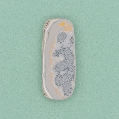 Heil Garbage Truck Fordite Free Form Caboceon, Heil (Milwaukee, WI) 41x17x3mm, 15.85ct