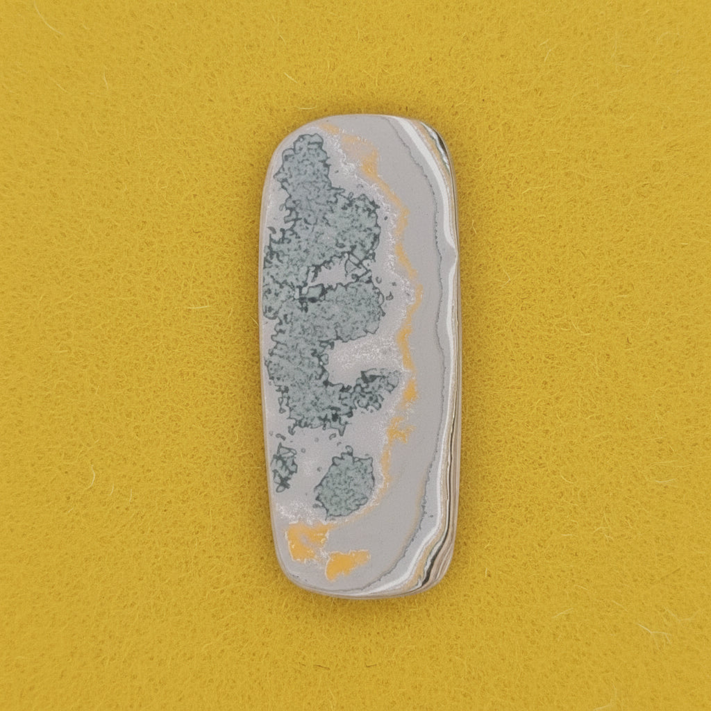 Heil Garbage Truck Fordite Free Form Caboceon, Heil (Milwaukee, WI) 41x17x3mm, 15.85ct