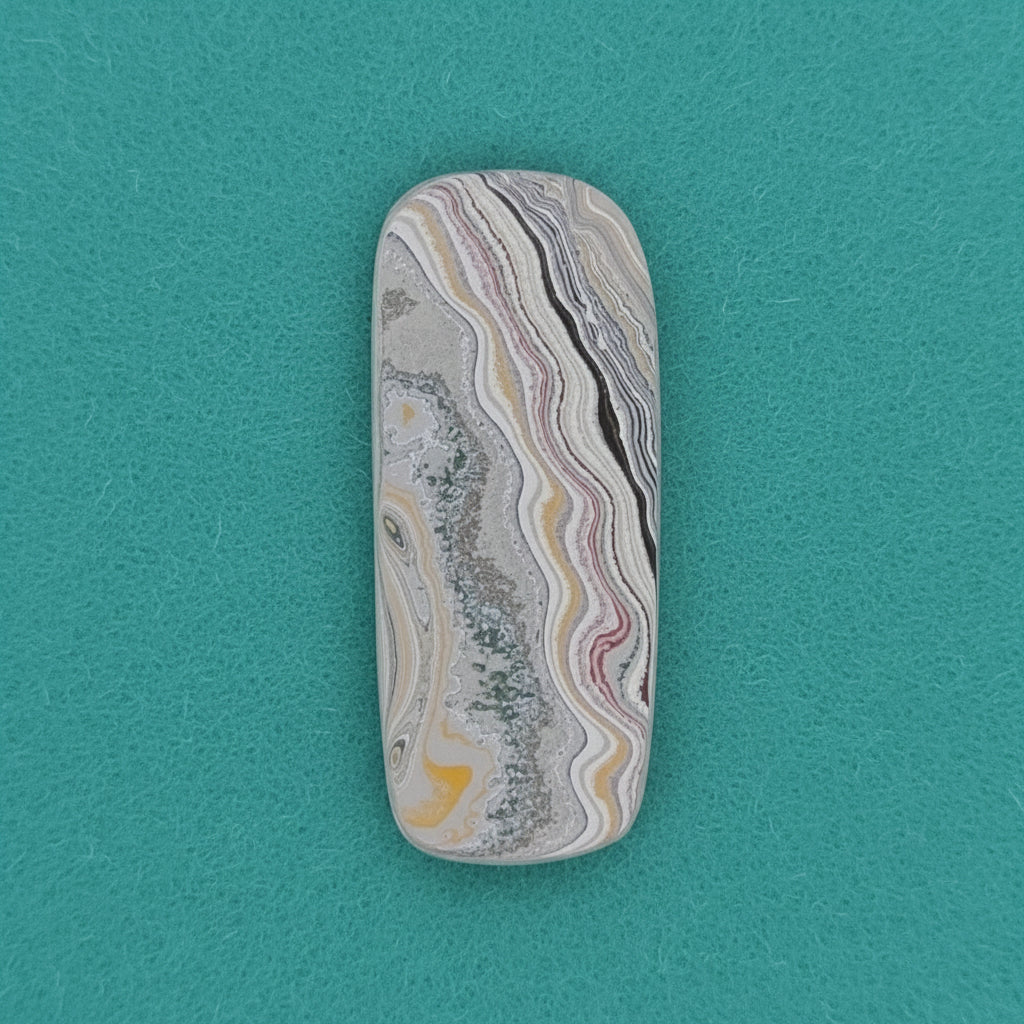 Heil Garbage Truck Fordite Free Form Caboceon, Heil (Milwaukee, WI) 41x17x3mm, 15.85ct
