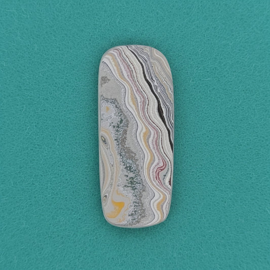 Heil Garbage Truck Fordite Free Form Caboceon, Heil (Milwaukee, WI) 41x17x3mm, 15.85ct