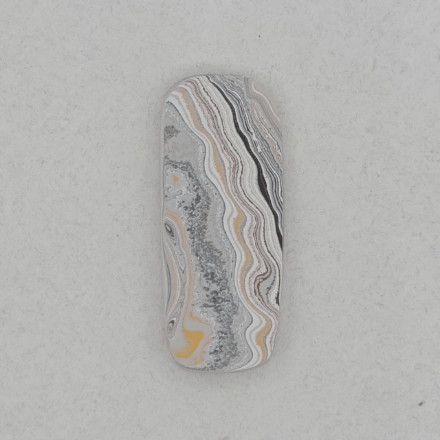 Heil Garbage Truck Fordite Free Form Caboceon, Heil (Milwaukee, WI) 41x17x3mm, 15.85ct